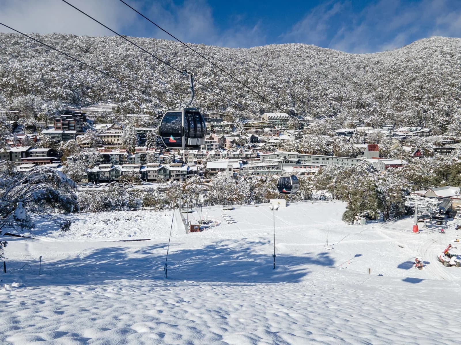 Thredbo village under snow, lodges and apartments along one side of the valley